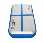 Portable blue AirTumble air block mat for floor exercises and balance practice.