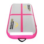 Durable pink inflatable air block with handles, designed for gymnastics jumps and training.