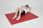 Child exercising on a red AirTumble agility gym mat for fitness and gymnastics practice.