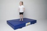 A picture of a girl jumping on the blue AirTumble Promat Crash Mat.