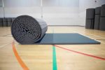 Rolled-out Air Tumble Track Gymnastics Mat on a gym floor, ready for tumbling or training use.