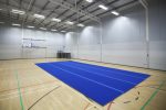 A picture of AirTumble Roll Mats on the surface of a gymnasium hall.